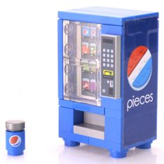 a blue toy machine sitting on top of a white table next to a pepsi sign