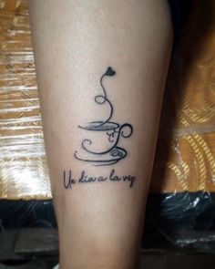 a tattoo on the leg of a person with a coffee cup and heart in it