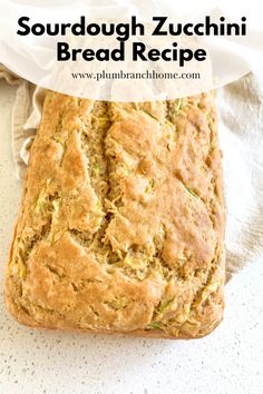 a loaf of sourdough zucchini bread sitting on top of a white towel