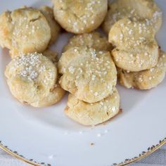 a white plate topped with cookies covered in sugar