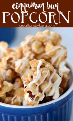 cinnamon bun popcorn in a blue bowl with white icing and drizzled on top