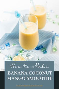 two glasses filled with banana coconut mango smoothie on top of a blue and white napkin