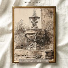 the fountain sketch is framed in an antique gold frame on a white linen background with text that reads, atheio art fountain sketch