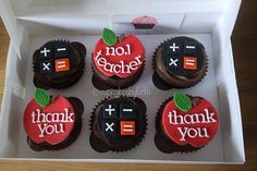 six decorated cupcakes in a box with the words thank you and an apple