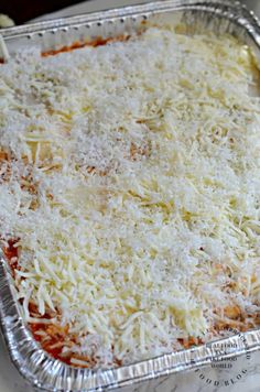 an uncooked casserole dish with cheese and sauce on it, ready to be eaten