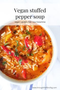 a bowl of vegan stuffed pepper soup on a white surface with text overlay