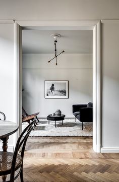 an open door leading to a living room and dining area