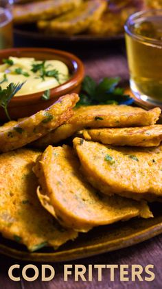 some food is sitting on a plate with dipping sauce