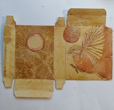 two pieces of paper that have been altered to look like birds on them, one has a circle in the middle