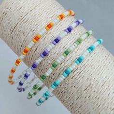 multicolored bracelets are stacked on top of each other