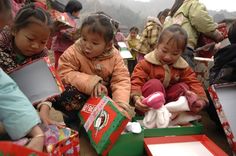 several children are sitting on the ground with presents