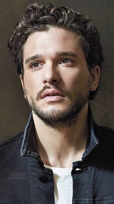 a black and white photo of a man with curly hair