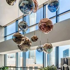 an office lobby with large windows and hanging glass balls in the center of the room