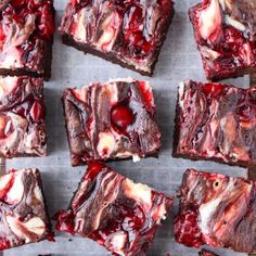 several pieces of brownies with cherries on them