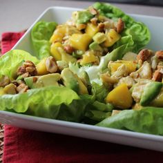 two lettuce wraps filled with fruit and nuts