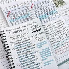 an open notebook sitting on top of a pile of papers with chinese characters written in it