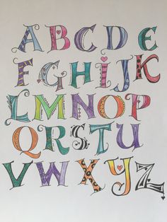 the letters and numbers are drawn with colored pencils on white paper, which has been placed