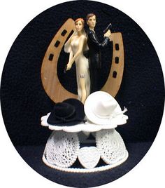 two figurines are sitting on top of hats