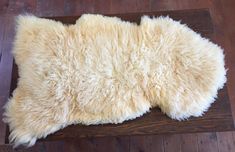 a sheepskin rug is laying on the floor