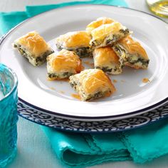 a white plate topped with pastries on top of a blue and white table cloth