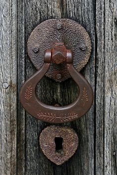 an old door handle on a wooden door