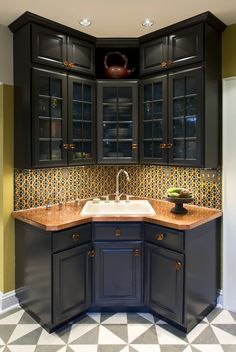 a kitchen with black cabinets and checkered flooring on the walls is pictured in this image