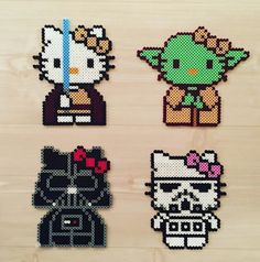 four different pixel art pieces on a wooden surface, each with an image of hello kitty and baby yoshi