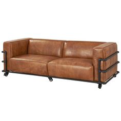 a brown leather couch sitting on top of a metal frame