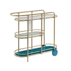 a gold serving cart with blue wheels and glass plates on the bottom shelf, against a white background