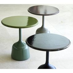 three round tables sitting on top of each other in the middle of a floored area