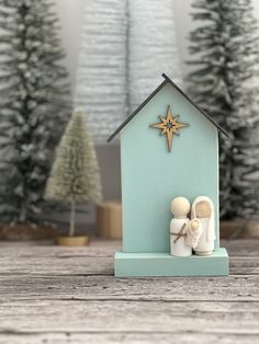 a nativity scene with two baby shoes and a star on the top of it