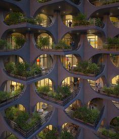 an apartment building with many balconies and plants growing on the sides of it