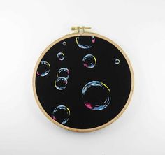 a black wall hanging with colorful bubbles on it