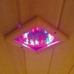 a bathroom with a pink light on the ceiling