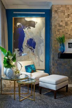 a living room with blue walls and white furniture