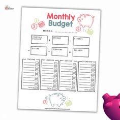 a pink piggy bank sitting next to a printable budget sheet