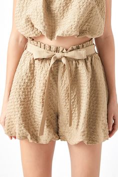 Looking for a cute and professional way to show off your legs? Look no further than our Bubble Elastic Shorts! Made from light brown fabric, these shorts are perfect for any occasion. Pair with the matching crop top or style with a white crop top to complete the look. Textured woven fabric Elastic waist Self fabric waist belt Shell: 50% Polyester 40% Rayon 10% Other Lining: 100% Polyester JJ861P Total length: 15" Waist: 27" Inseam: 3" XS TAN: Height 5'9" / Bust 30.5" / Waist 24" / Hips 34.5" Elastic Shorts, Brown Fabric, White Crop, White Crop Top, Waist Belt, Light Brown, Woven Fabric, Elastic Waist, Lookbook