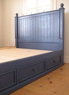 the bed is made and has two drawers on each side