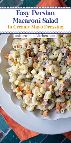 a white bowl filled with macaroni salad on top of a blue and orange napkin