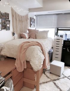 a bedroom with a bed, desk and pictures on the wall