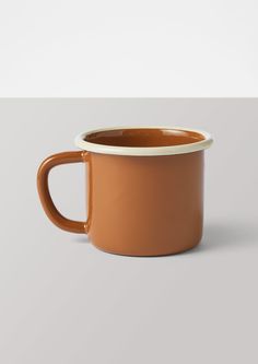 a brown coffee cup sitting on top of a table