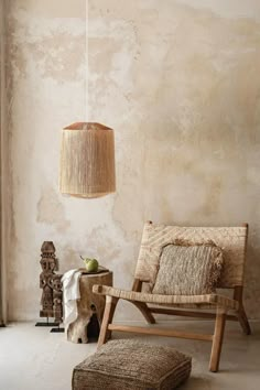 a wooden chair sitting next to a lamp in a room