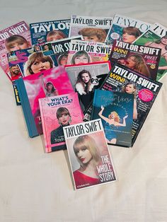 several magazines laying on top of a bed next to each other with covers pulled back