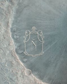 the letter n is etched into the sand