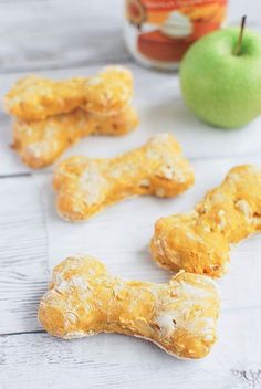 some dog treats and an apple on a table