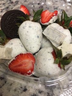 a bowl filled with ice cream and strawberries on top of a marble countertop