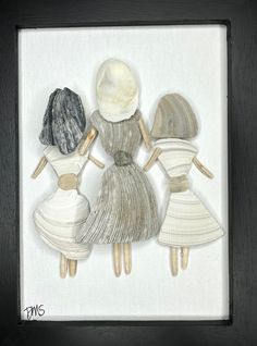 three women in dresses and hats are holding their hands together