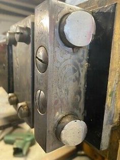 an old metal door with some knobs on it