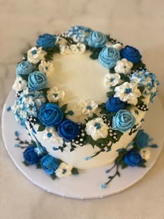 a cake with blue and white flowers on it