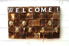 a wooden sign that says welcome with several locks on it and the word'welcome'written in white letters